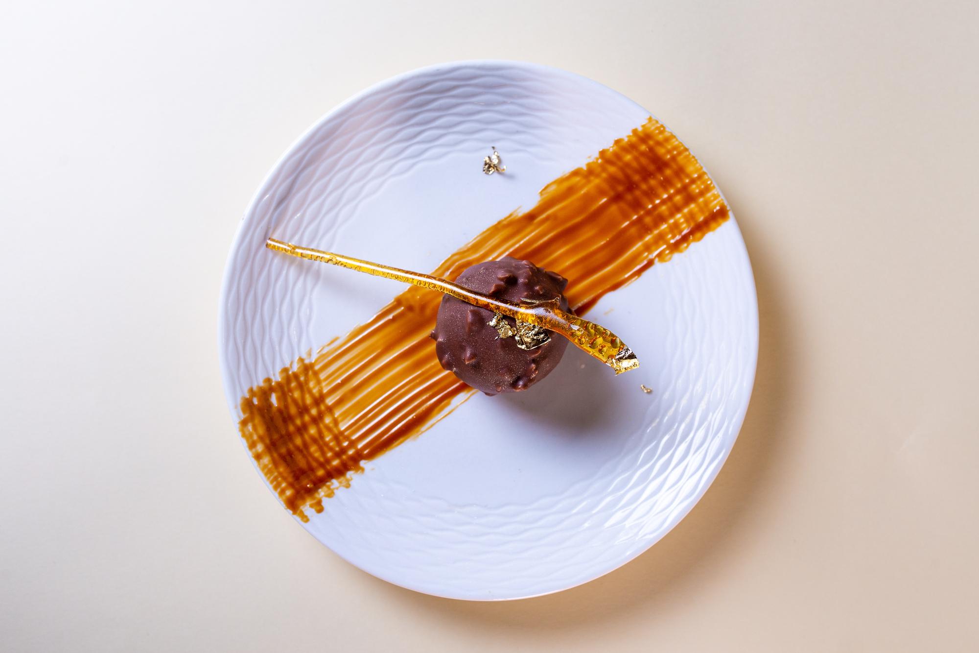 Asymmetric plated dessert with gold leaf